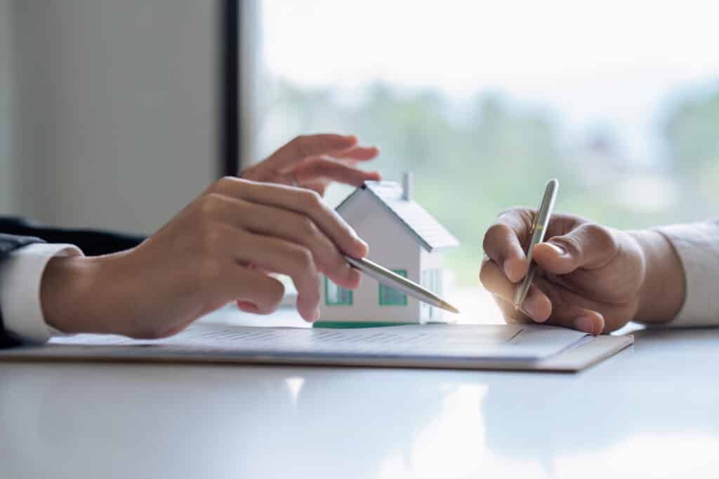 Professional real estate agent guiding and explaining the document process to the customer