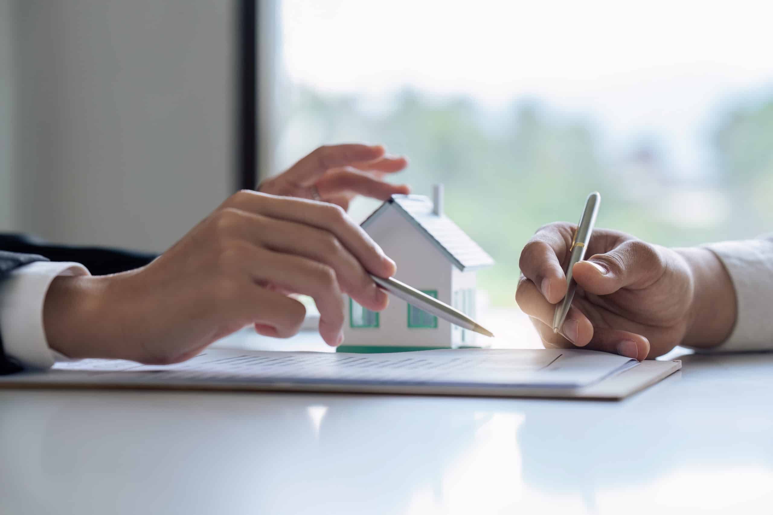 Professional real estate agent guiding and explaining the document process to the customer